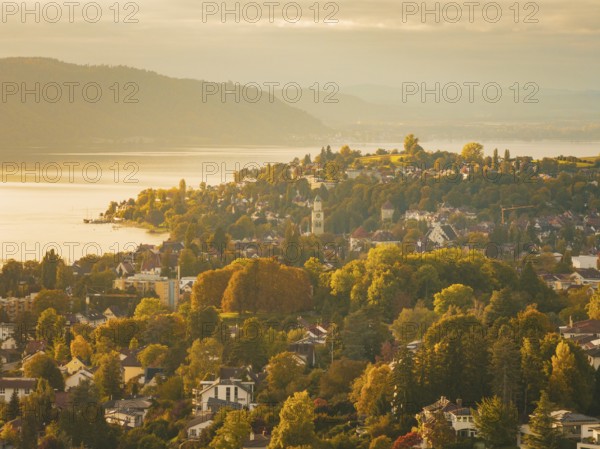 Above a town with a view of a lake and surrounded by autumn trees, Überlingen, Lake Constance, Germany