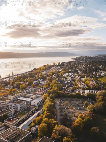 Aerial view of a lakeside town in autumn weather with beautiful clouds and buildings, Überlingen, Lake Constance, Germany