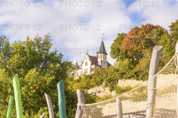 Old castle surrounded by autumn trees and blue sky, Überlingen, Lake Constance, Germany