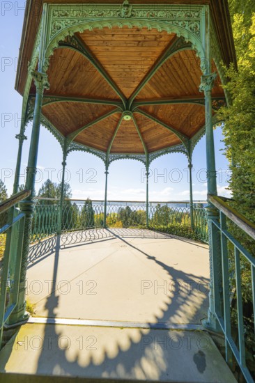 Historic metal pavilion with wooden ceiling surrounded by bright daylight and shade, Überlingen, Lake Constance, Germany