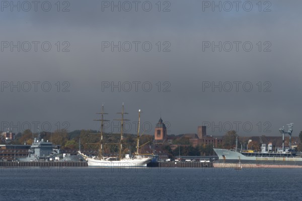Kiel naval port, district of Wik, sailing school ship Gorch Fock in their home port, fuel transporter A1442 Spessart of the German Navy, supply ship A512, tower of the Garrison Church of St. Peter's Church, Schleswig-Holstein, Germany