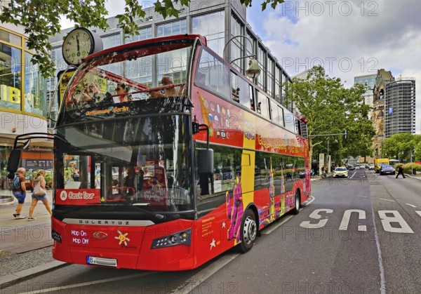 Double-decker bus for the city tour on Tauentzienstraße with Kaiser Wilhelm Memorial Church, Charlottenburg, Berlin, Germany
