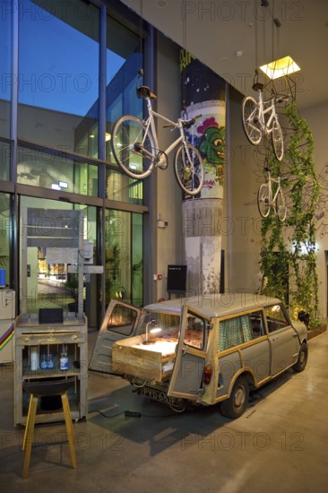 Entrance area to Monkey Bar with old Trabi in the evening, Charlottenburg, Berlin, Germany