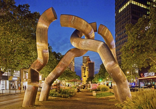 The sculpture entitled Berlin by Brigitte and Martin Matschinsky-Denninghoff with Kaiser Wilhelm Memorial Church in the evening, Charlottenburg, Berlin, Germany