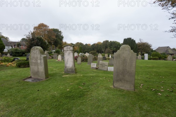 Cemetery of St John's Church with gravestones telling the story of seafarers, known as talking gravestones, Nieblum, Föhr Island, Schleswig-Holstein, Germany