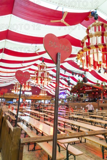 Festively decorated marquee with red blankets, wooden benches and heart-shaped sign, Cannstatter Wasen folk festival, Sonja Merz marquee, Stuttgart, Germany