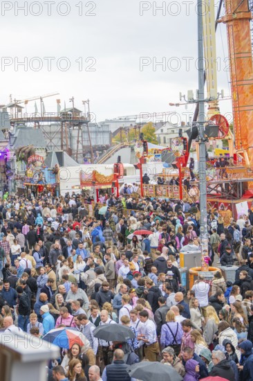Large crowd at a lively folk festival with various rides and a lively atmosphere, Cannstatter Wasen folk festival, Sonja Merz Festzelt, Stuttgart, Germany