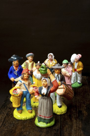 Colorful Provençal terracotta figurines represent traditional characters from rural life. Each figure is uniquely crafted, depicting musicians, farmers, and market sellers in detailed attire