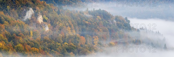 View of Benedictine monastery Beuron, Archabbey of St. Martin, limestone rock, rock face, mixed forest, autumn colours, fog, autumn, Fridingen, Danube Valley, Upper Danube nature park Park, Baden-Württemberg, Germany