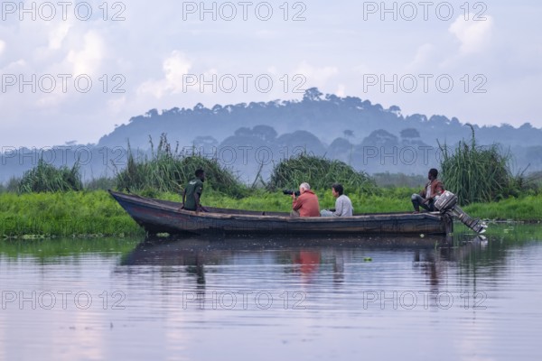 Boat with tourists in Mabamba Swamp, tourists photographing birds, Mabamba Swamp, Lake Victoria, Uganda