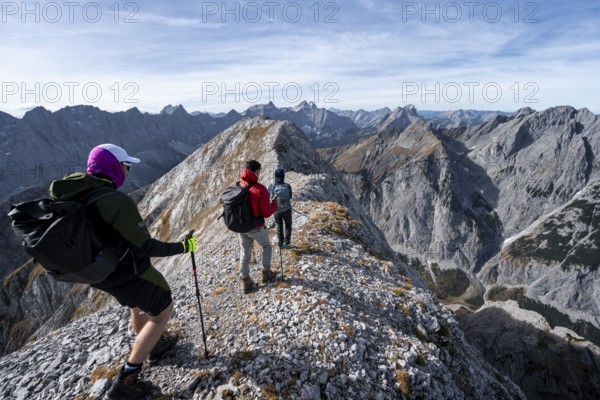 Mountain panorama, group of mountaineers on the ridge of the Gamsjoch, transition to the main summit of the Gamsjoch, behind western summit with summit cross, behind mountain ridge of the Hinterautal-Vomper chain, in autumn, Rißtal in the Eng, Karwendel, Tyrol, Austria
