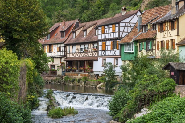 Picturesque Kaysersberg with half-timbered houses on the Weiss river in the old town centre