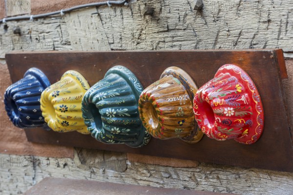 Traditional colourful Guglhupf cake tins from a bakery in Kaysersberg