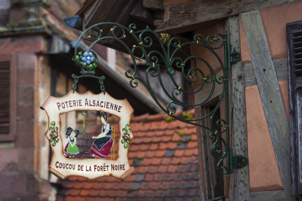 Historic guild sign of a clothing shop in the old town centre of Kaysersberg
