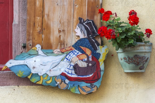 Historic decorated window with geese in Alsace