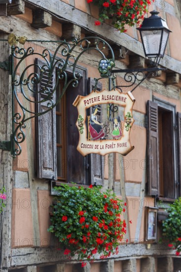 Historic guild sign of a clothing shop in the old town centre of Kaysersberg