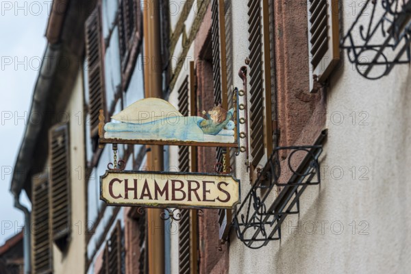 Historic guild sign of a guesthouse in the old town centre of Kaysersberg