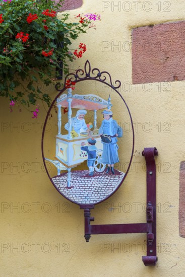 Historic guild sign of an ice cream parlour in the old town of Kaysersberg