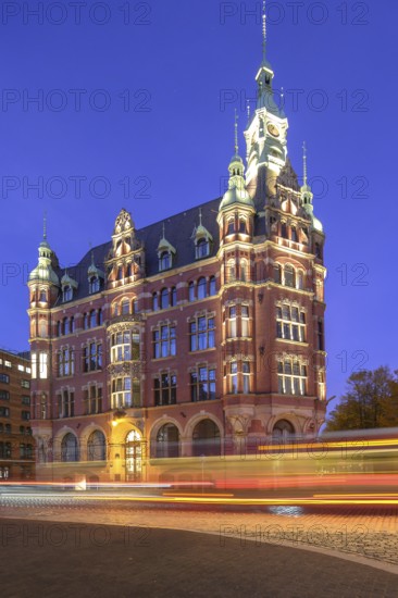 Speicherstadt town hall in Hamburg's Speicherstadt warehouse district at blue hour with traces of vehicles in the foreground, Hamburg, Germany