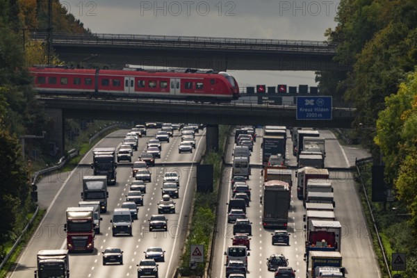Local train crossing the A3 motorway between the Hilden junction and the Mettmann junction, view to the south, traffic jam due to construction work, North Rhine-Westphalia, Germany