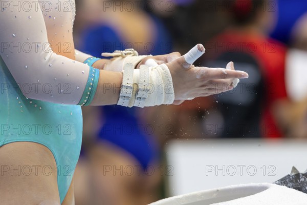 Symbolic image of gymnastics apparatus: close-up of a gymnast preparing for the next apparatus