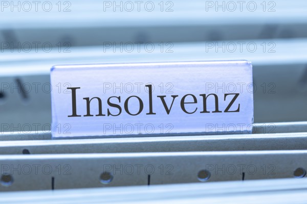 (Photomontage) Sign with the inscription INSOLVENCE on a suspension file folder