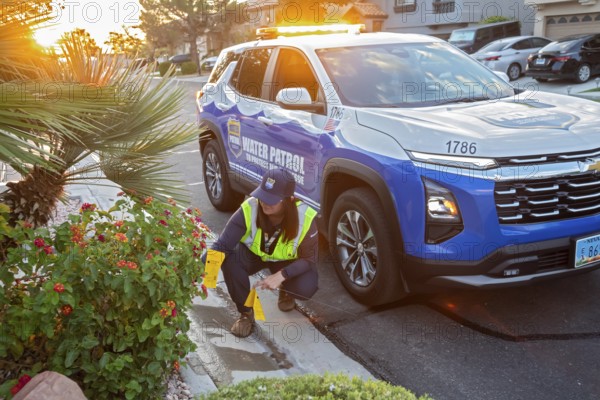 Las Vegas, Nevada - Devyn Choltko, a water waste investigator, patrols a residential neighborhood issuing tickets for illegal water use. The Las Vegas Valley Water District has cut usage of scarce Colorado River water by more than 30% over the last 20 years despite a growing population