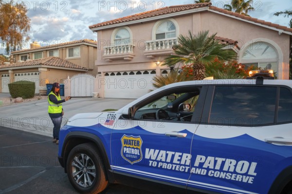 Las Vegas, Nevada - Devyn Choltko, a water waste investigator, patrols a residential neighborhood, recording and issuing tickets for illegal water use. The Las Vegas Valley Water District has cut usage of scarce Colorado River water by more than 30% over the last 20 years despite a growing population