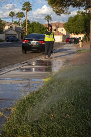 Las Vegas, Nevada - Devyn Choltko, a water waste investigator, patrols a residential neighborhood, recording and issuing tickets for illegal water use. The Las Vegas Valley Water District has cut usage of scarce Colorado River water by more than 30% over the last 20 years despite a growing population