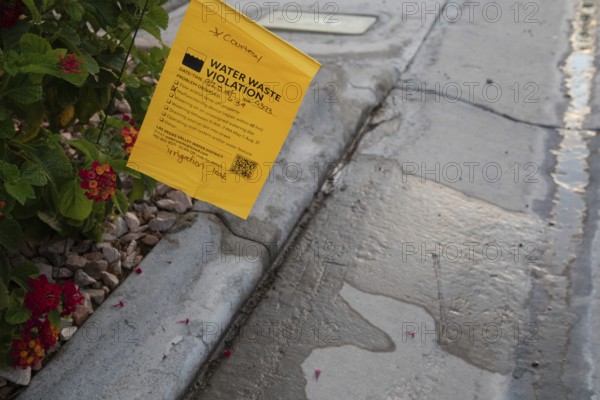 Las Vegas, Nevada - Water waste investigators patrol residential neighborhoods, issuing tickets for illegal water use. The Las Vegas Valley Water District has cut usage of scarce Colorado River water by more than 30% over the last 20 years despite a growing population