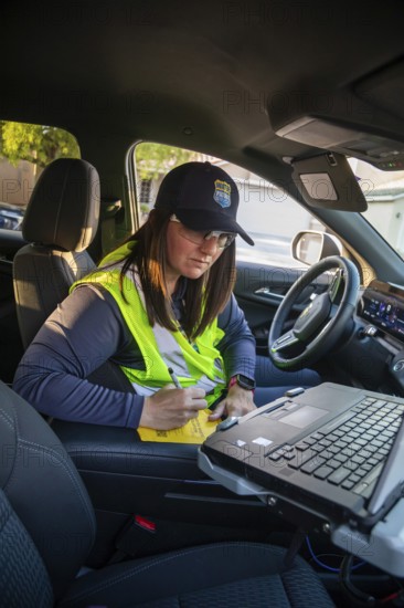 Las Vegas, Nevada - Devyn Choltko, a water waste investigator, patrols a residential neighborhood issuing tickets for illegal water use. The Las Vegas Valley Water District has cut usage of scarce Colorado River water by more than 30% over the last 20 years despite a growing population