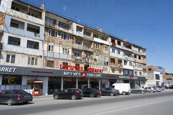 A multi-storey residential building with shops on the ground floor on a busy street, Norapat, Armavir Province, Armenia