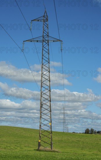 Electric power line in open landscape with clouds in Ystad municipality, Skåne county, Sweden, Scandinavia
