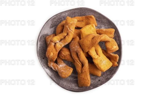 Crunchy biscuit Brushwood cookies sprinkled with powdered sugar isolated on white background, top view, flat lay, close up