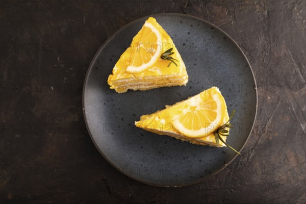 Lemon cake on black concrete background, top view, flat lay, close up