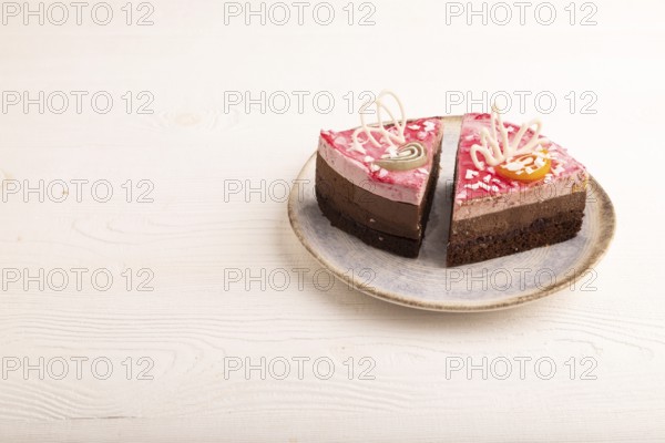 Chocolate cake on white wooden background, side view, copy space