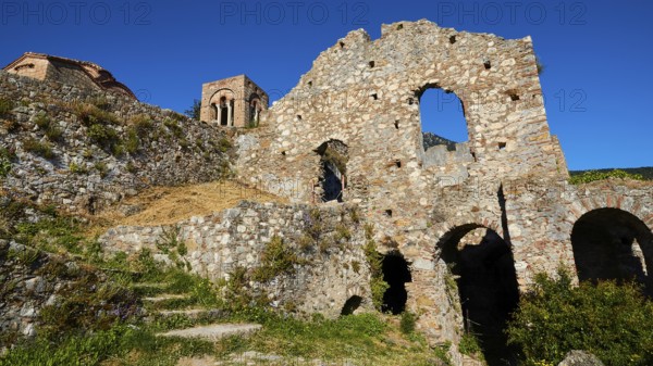 Church of Agia Sophia from the 14th century AD, Ancient ruins with stone arches and old walls in a natural setting with blue skies, Mystras, Mistra, UNESCO World Heritage Site, Medieval Byzantine ruined city, north-west of Sparta, foothills of the Tyagetos Mountains, Peloponnese, peninsula, Greece