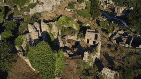 Drone image, Ancient, overgrown ruins in a natural, wooded environment, Mystras, Mistra, UNESCO World Heritage Site, Medieval Byzantine ruined city, northwest of Sparta, foothills of the Tyagetos Mountains, Peloponnese, peninsula, Greece