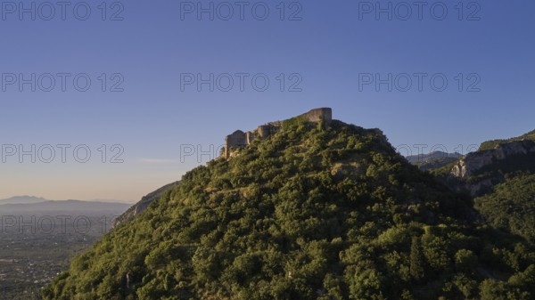 Byzantine castle from the 13th century AD on a green hill in the sunrise, surrounded by forest, Mystras, Mistra, UNESCO World Heritage Site, Medieval Byzantine ruined city, northwest of Sparta, foothills of the Tyagetos Mountains, Peloponnese, peninsula, Greece