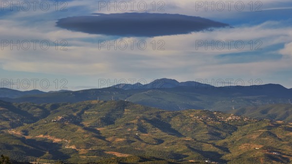 A cloud formation hovers over a wide, hilly landscape under a blue sky, view from Mystras to the mountains, Mystras, Mistra, UNESCO World Heritage Site, Medieval Byzantine ruined city, northwest of Sparta, foothills of the Tyagetos Mountains, Peloponnese, Peninsula, Greece