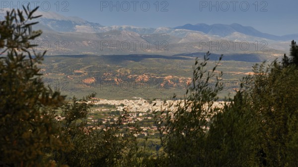 View of a valley, framed by high mountains and dense vegetation, view of Sparta, Mystras, Mistra, UNESCO World Heritage Site, Medieval Byzantine ruined city, northwest of Sparta, foothills of the Tyagetos Mountains, Peloponnese, Peninsula, Greece