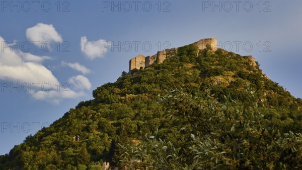 Byzantine castle of Mystras, rising on a wooded hill against the backdrop of a blue sky with clouds, Mystras, Mistra, UNESCO World Heritage Site, Medieval Byzantine ruined city, northwest of Sparta, foothills of the Tyagetos Mountains, Peloponnese, peninsula, Greece