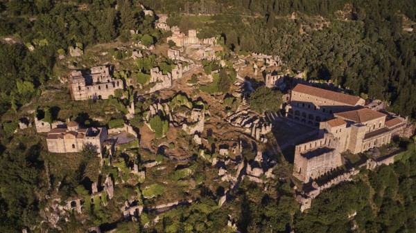 Aerial view of a large part of the Byzantine city of Mystras, surrounded by forest and mountains, Mystras, Mistra, UNESCO World Heritage Site, Medieval Byzantine ruined city, northwest of Sparta, foothills of the Tyagetos Mountains, Peloponnese, peninsula, Greece