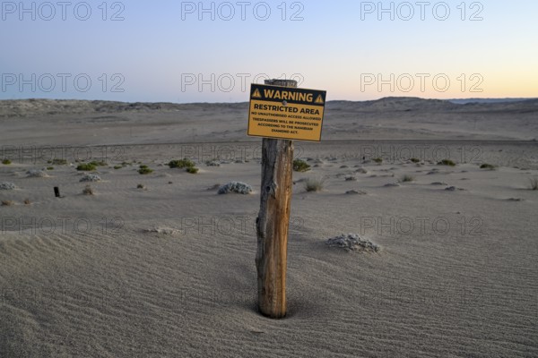 Restricted Area sign in the desert sand, Kolmanskop, diamond restricted area, near Lüderitz, Karas region, Namibia