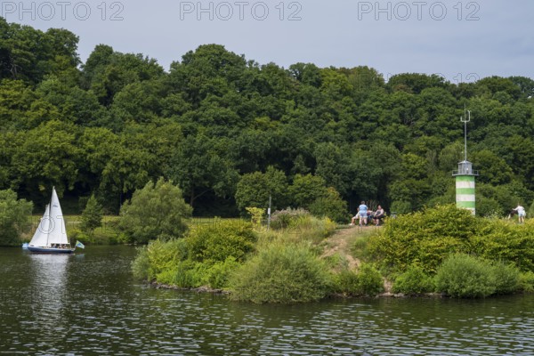 Lighthouse on an island on Lake Kemnader, people on the island, Heveney, Witten, Ruhr area, North Rhine-Westphalia, Germany