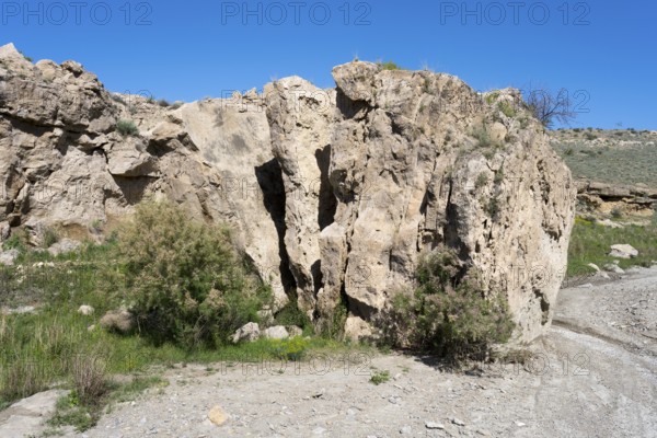 Rough rocky area with little vegetation and blue sky above, Stone Book, landscape near Dashtakar, Ararat Province, Armenia