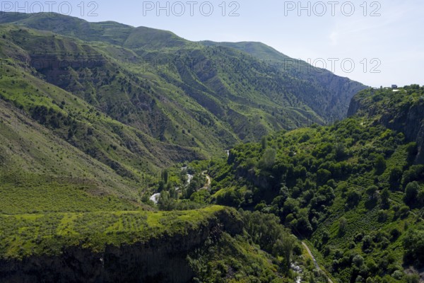 Deep gorge with dense green vegetation and wooded slopes under a clear sky, Garni Gorge, Azat River, Kotayk Province, Armenia