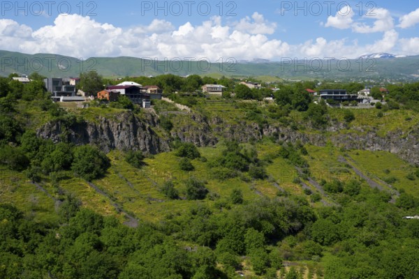 Hilly landscape with scattered houses and dense greenery under a blue sky, Garni Gorge, Azat River, Kotayk Province, Armenia