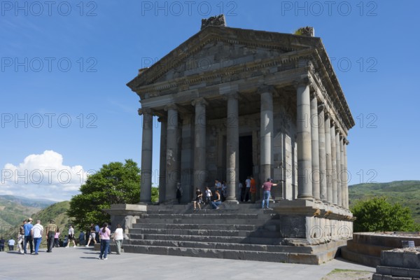 Ancient temple with visitors, surrounded by green nature and stone structures, Greek-Roman Temple of the Sun, Temple of Garni, Garni, Kotayk Province, Armenia