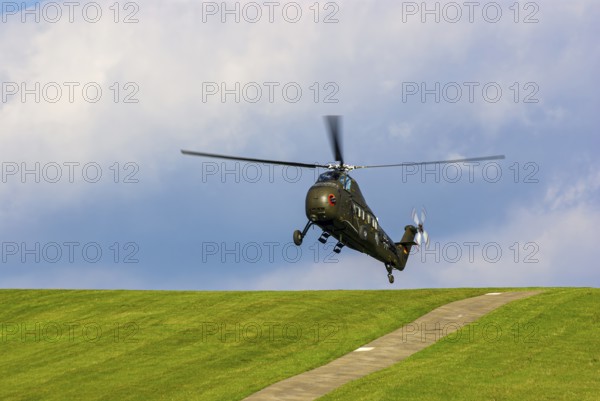 A Sikorsky S-58C transport helicopter in the colours of the German Army with the registration D-HAUG during a flight demonstration as part of an air show at the Rossfeld in Metzingen-Glems, Baden-Württemberg, Germany, for editorial use only